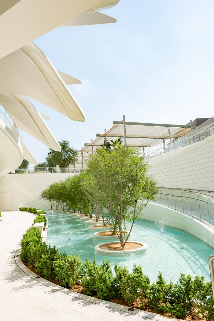 why-choose-us Elegant pavilion architecture with trees and water, showcasing modern design elements.