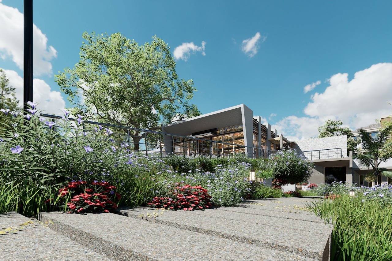 services-05 Elegant modern building surrounded by a vibrant garden under a clear blue sky.